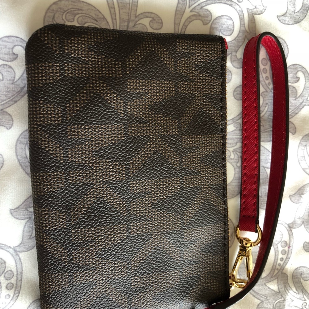 Micheal Kors monogrammed wristlet